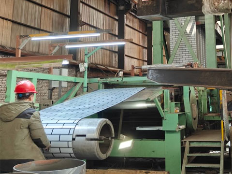 Brick-patterned steel coil is being coiled