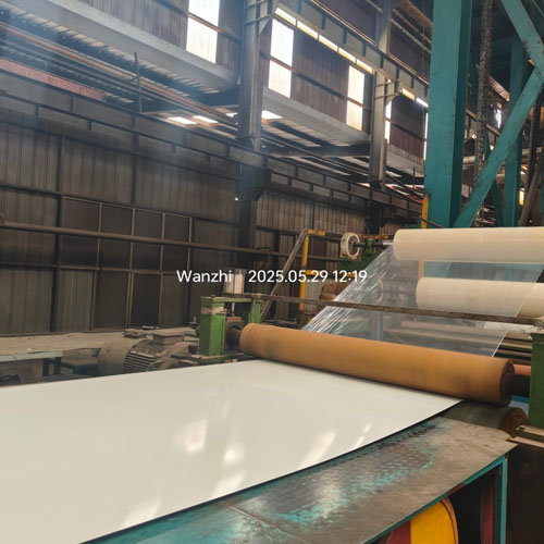 White steel coils are being laminated.